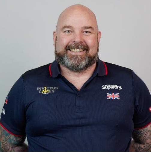 Personnel wears Invictus Games uniform in portrait.